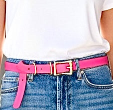Woman wearing pink belt and brass buckle with jeans and white t-shirt
